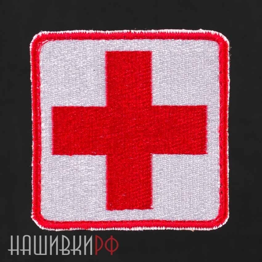 Эмблема красный крест на белом фоне